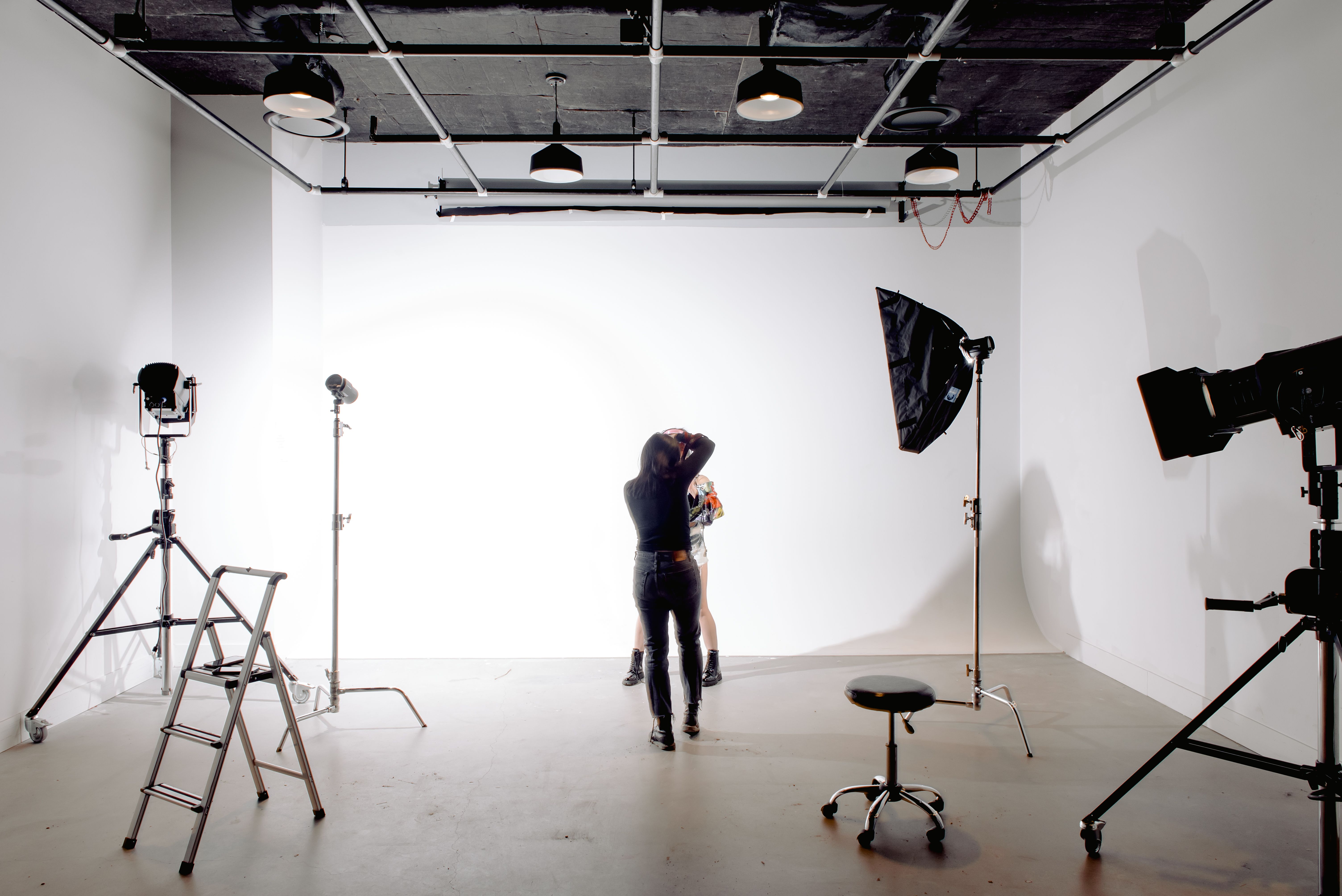 Professional photographer setting up a portrait shoot in a London photography studio