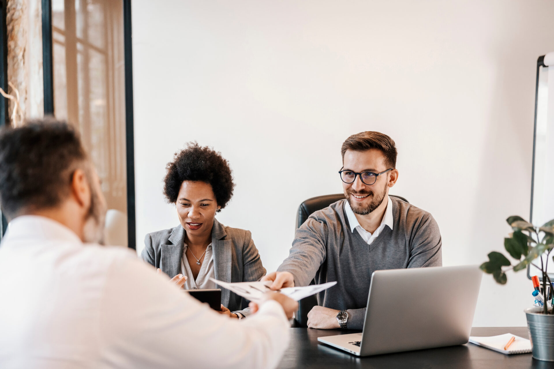 London recruitment agency consultants reviewing candidate profiles and conducting interviews in a modern office