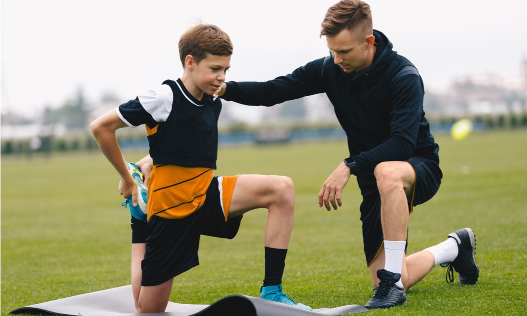 London sports coach working with an athlete on a track, demonstrating professional coaching qualifications