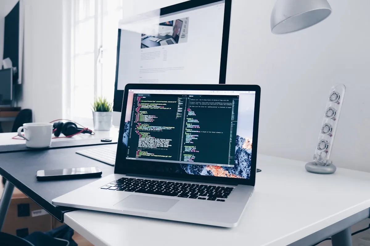 Developer providing website support and maintenance on a laptop in a professional London office setting