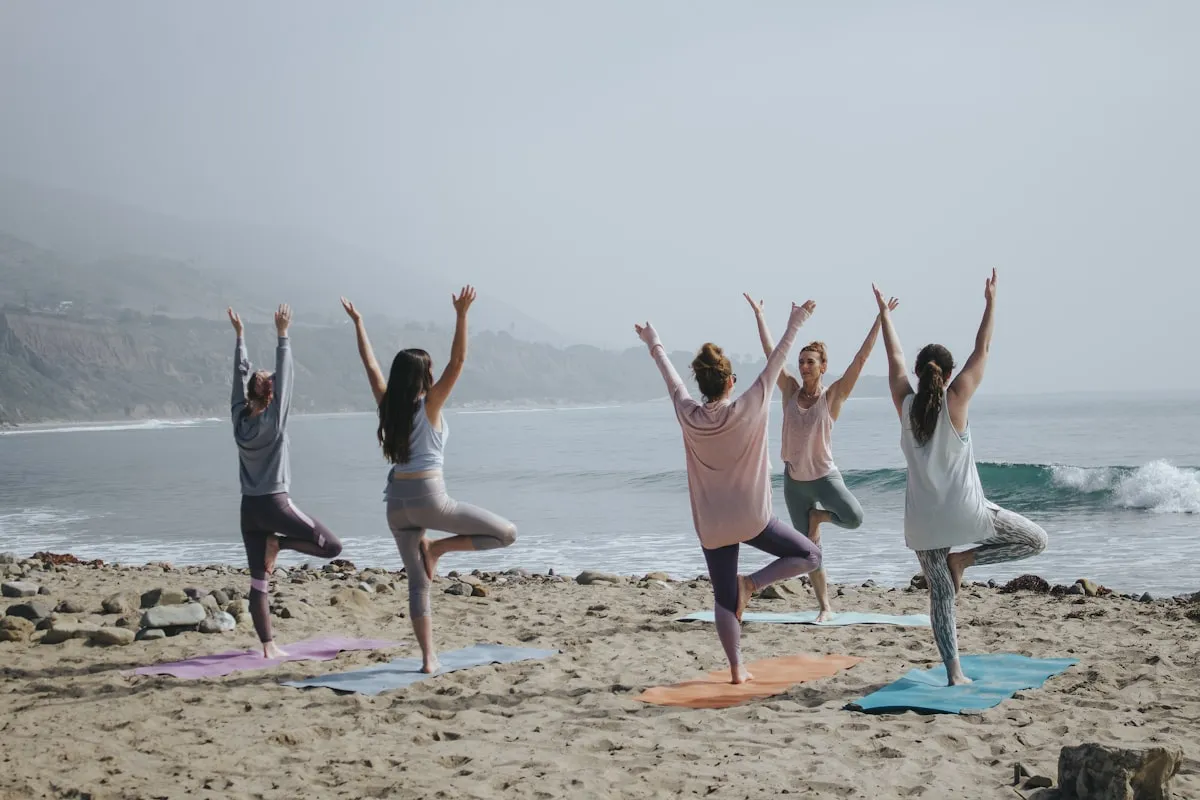 Bright London yoga studio with students practicing on mats during a morning group class
