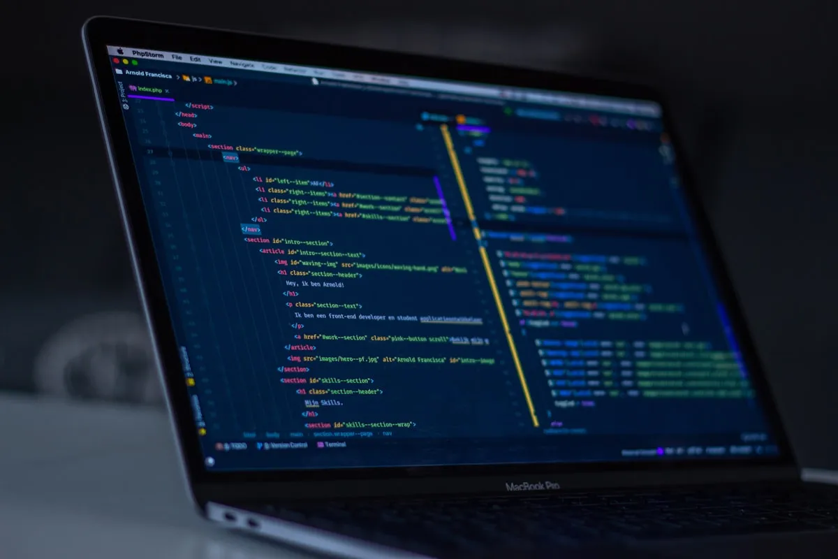 App development team reviewing code and UX wireframes in a London development studio.